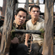 Mark Wahlberg as Sully and Tom Holland as Drake stand on a pirate ship and look surprised in the Uncharted movie.